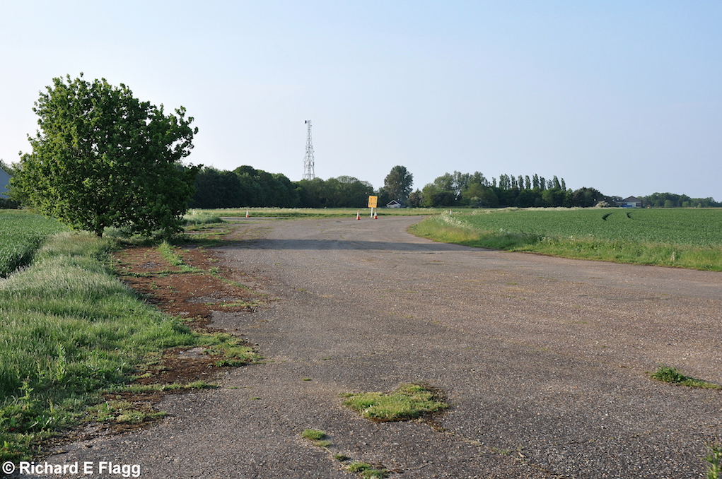 007Taxiway at the west of the airfield. Looking north from near the runway 06 threshold - 18 May 2014.png